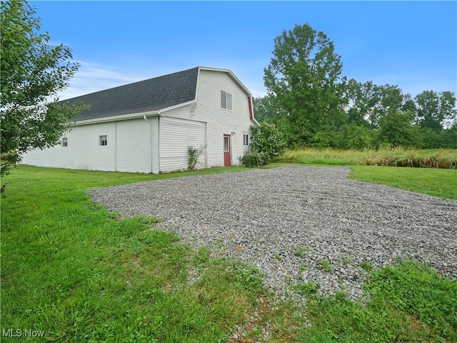 exterior space featuring an outbuilding and a yard