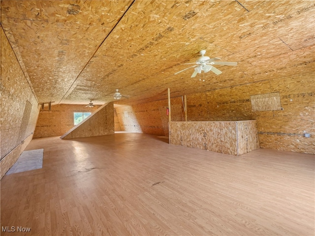 bonus room with hardwood / wood-style flooring and ceiling fan