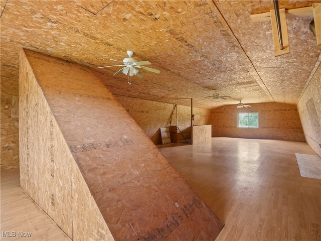 additional living space with light wood-type flooring and lofted ceiling