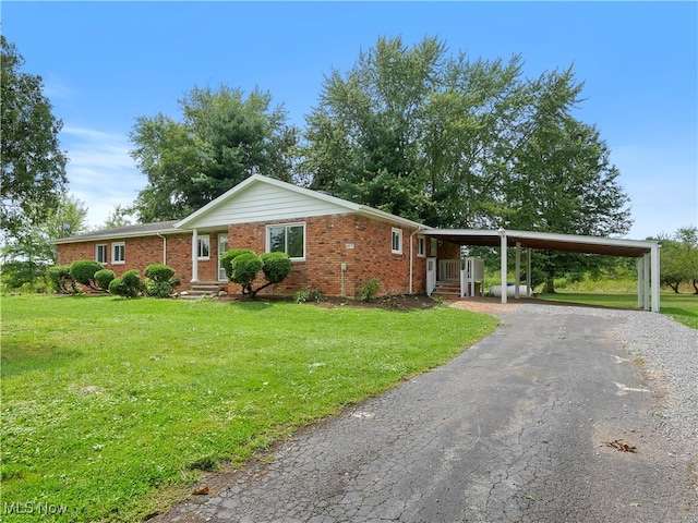 ranch-style house featuring a carport and a front lawn