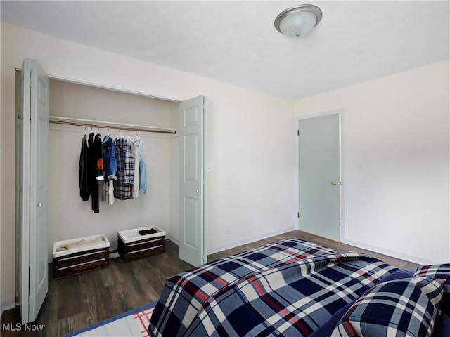 bedroom featuring dark hardwood / wood-style flooring and a closet