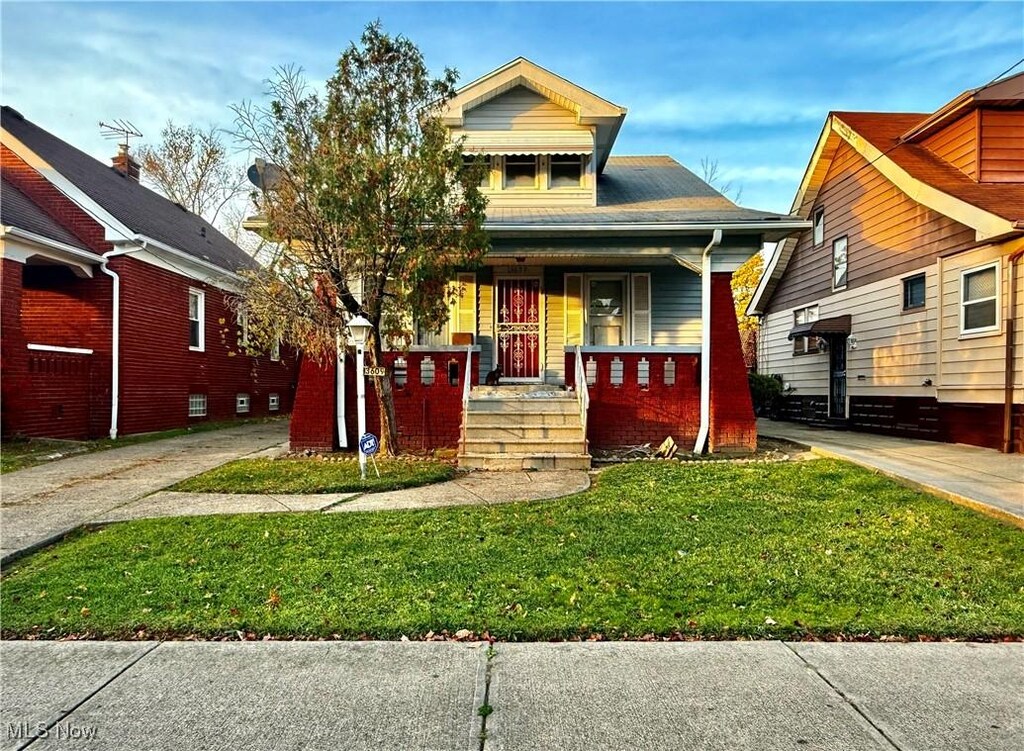 13609 Melzer Ave, Cleveland, OH 44120 - view of front of property featuring a front yard and a porch