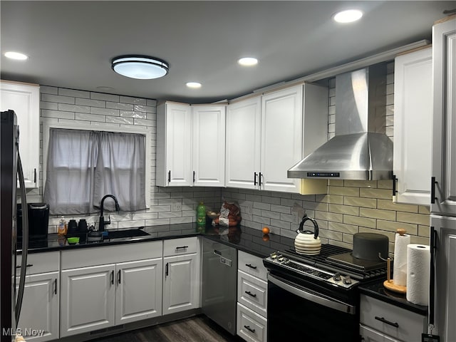 kitchen with black range with electric stovetop, white cabinetry, sink, wall chimney exhaust hood, and stainless steel dishwasher