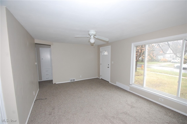 empty room featuring ceiling fan and carpet floors