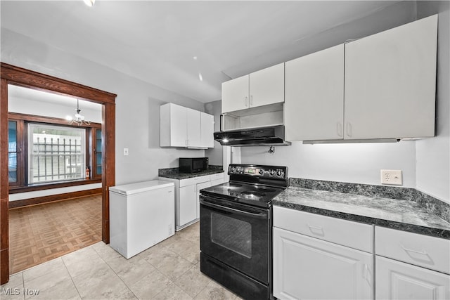 kitchen with light parquet flooring, exhaust hood, black appliances, white cabinets, and a chandelier