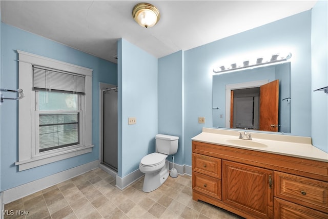 bathroom with vanity, an enclosed shower, and toilet