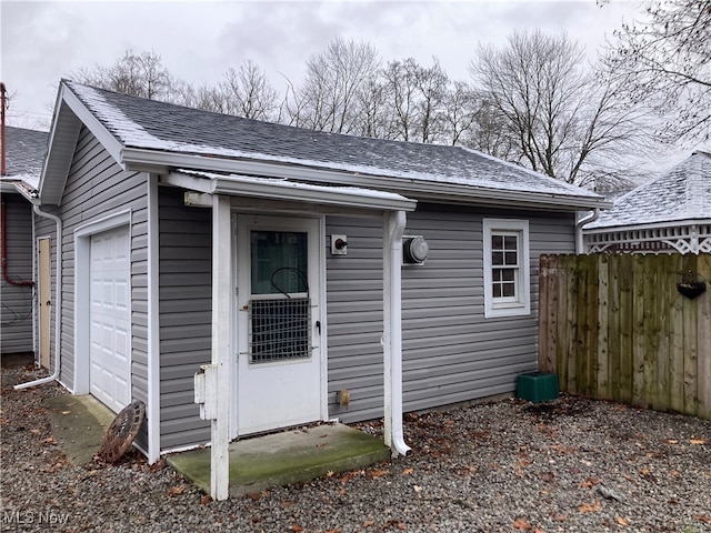 view of front facade featuring a garage and an outdoor structure