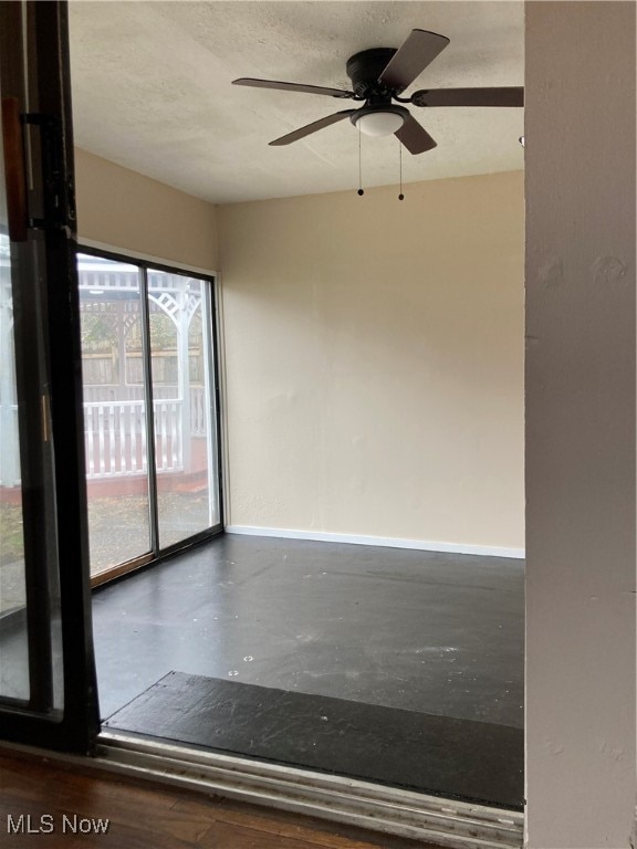 empty room featuring ceiling fan and a textured ceiling