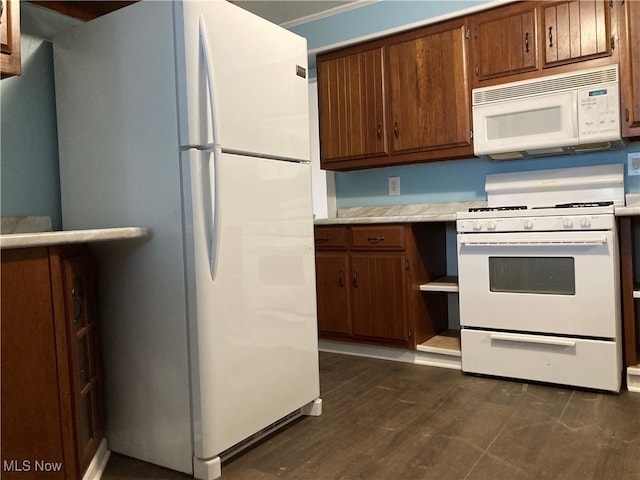 kitchen featuring white appliances and dark hardwood / wood-style floors