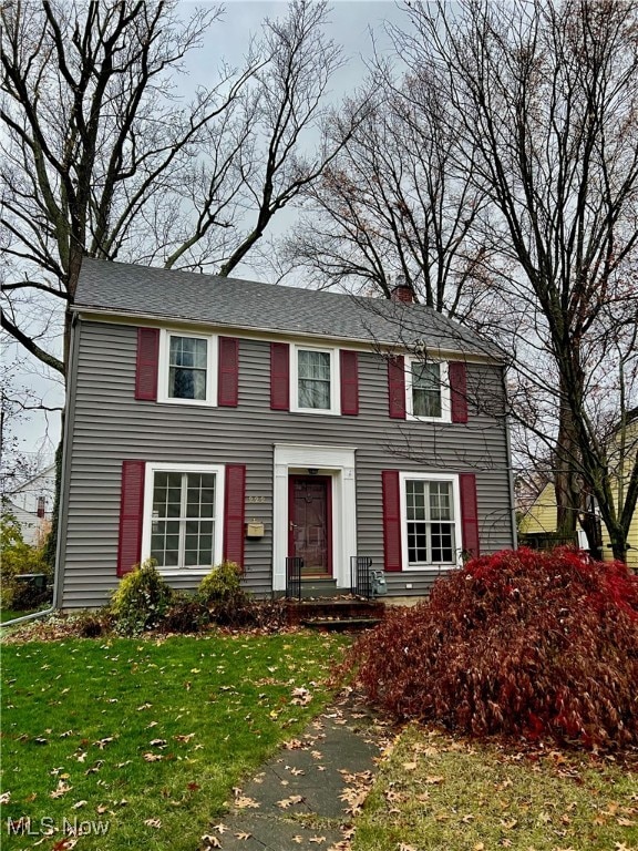 colonial-style house with a front lawn