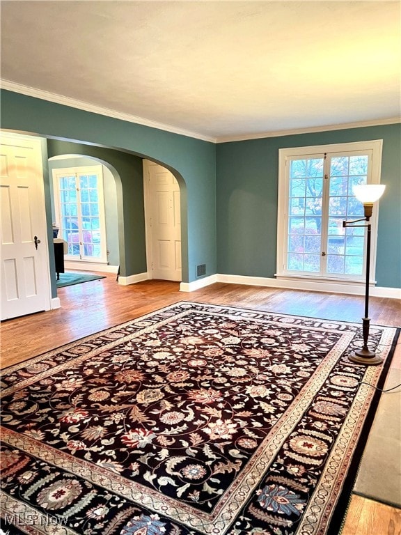 living room featuring wood-type flooring and ornamental molding