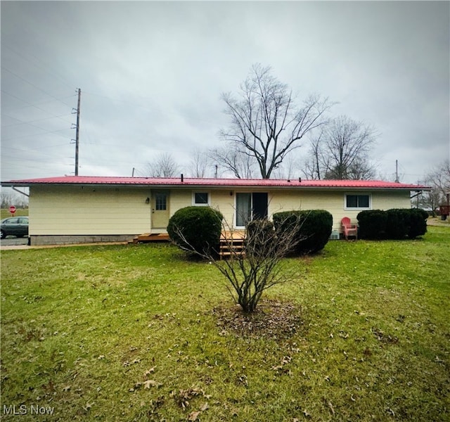 rear view of house with a yard