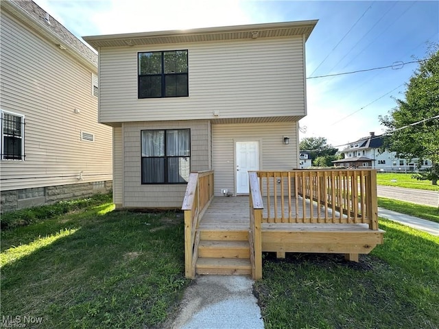 back of house with a yard and a wooden deck