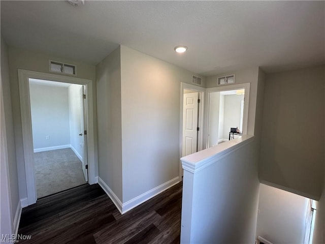 corridor featuring dark hardwood / wood-style flooring