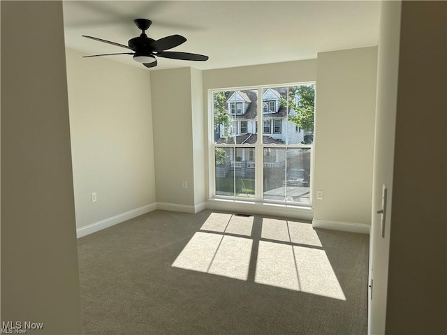 unfurnished room with carpet and ceiling fan