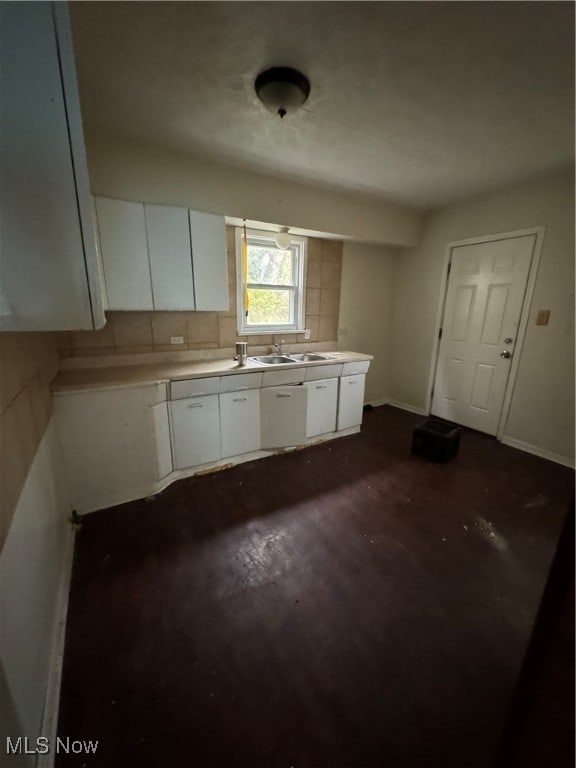 kitchen featuring white cabinets, tasteful backsplash, and sink