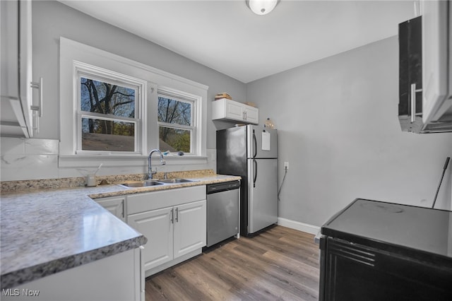 kitchen with white cabinets, stainless steel appliances, dark hardwood / wood-style floors, and sink