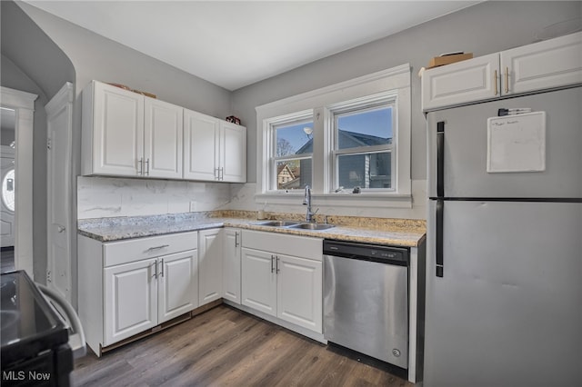 kitchen with white cabinetry, sink, dishwasher, dark hardwood / wood-style floors, and white refrigerator