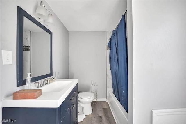 full bathroom featuring shower / bath combo with shower curtain, toilet, vanity, and hardwood / wood-style flooring