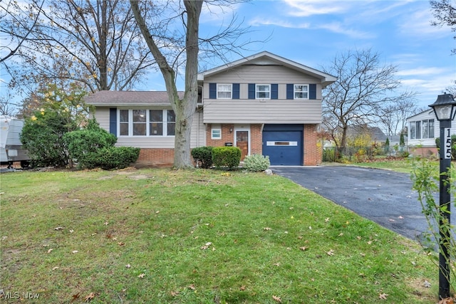 tri-level home featuring a garage and a front lawn