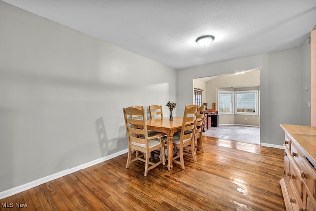 dining space featuring hardwood / wood-style floors and a textured ceiling