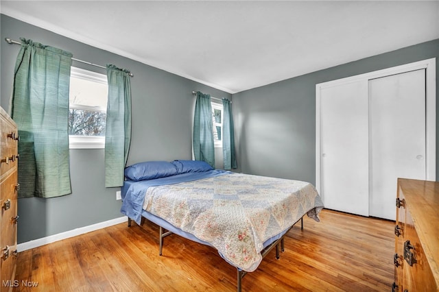 bedroom with a closet and light hardwood / wood-style flooring