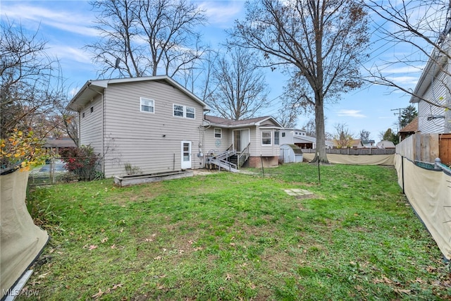 rear view of property with a yard