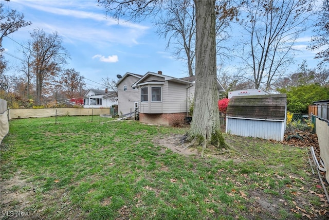 back of property with a shed and a lawn