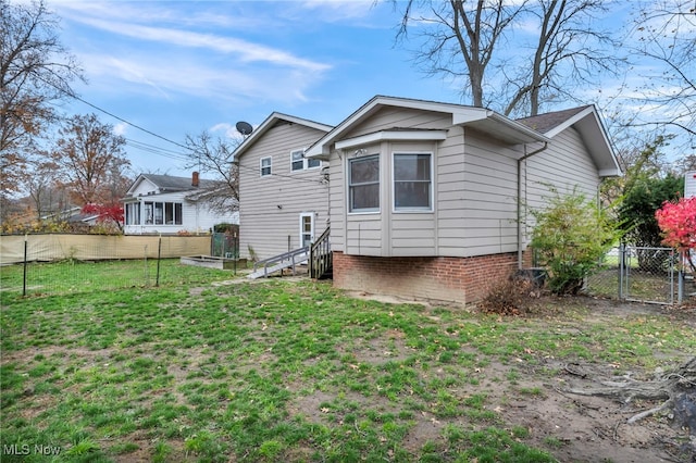 back of property featuring a lawn