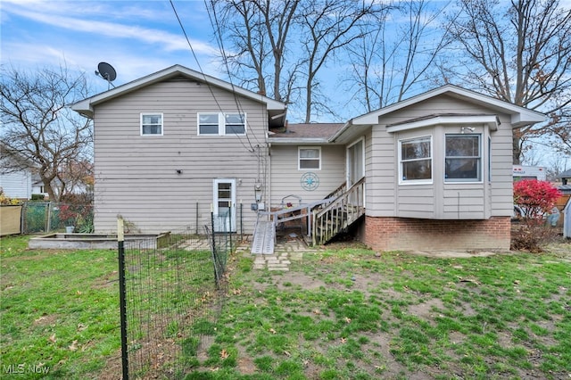 back of house with a lawn