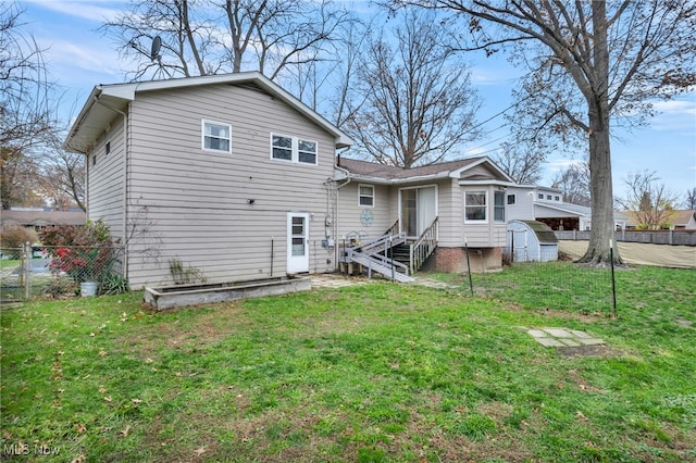 rear view of house featuring a lawn