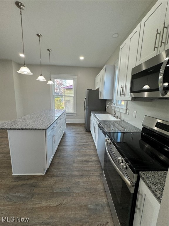 kitchen featuring sink, stainless steel appliances, light stone counters, dark hardwood / wood-style flooring, and white cabinets