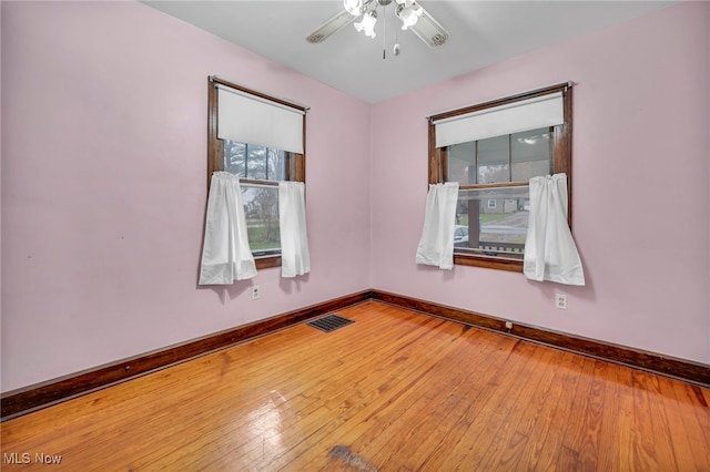 spare room with hardwood / wood-style floors and ceiling fan