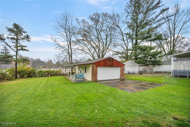 view of yard with a garage and an outdoor structure