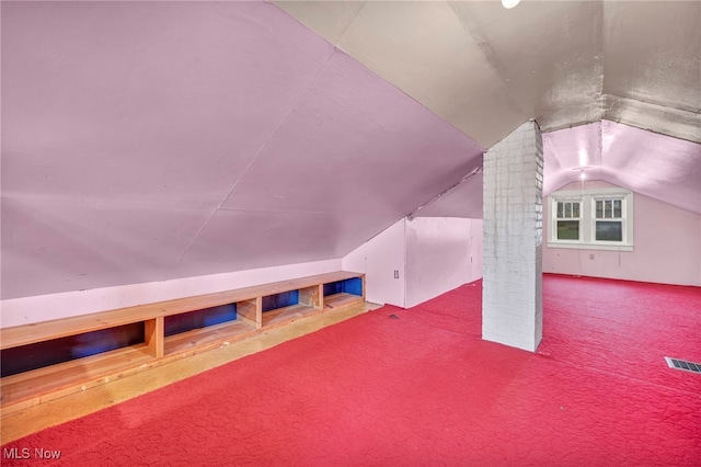 bonus room featuring lofted ceiling and carpet floors