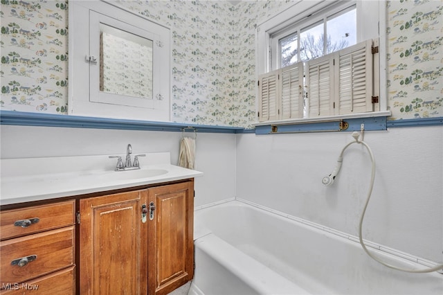 bathroom with a tub and vanity