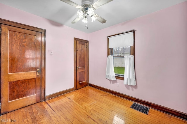 empty room featuring ceiling fan and light hardwood / wood-style flooring