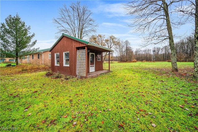 exterior space with an outdoor structure and a yard