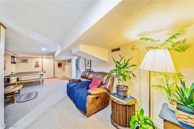 playroom featuring carpet and a textured ceiling