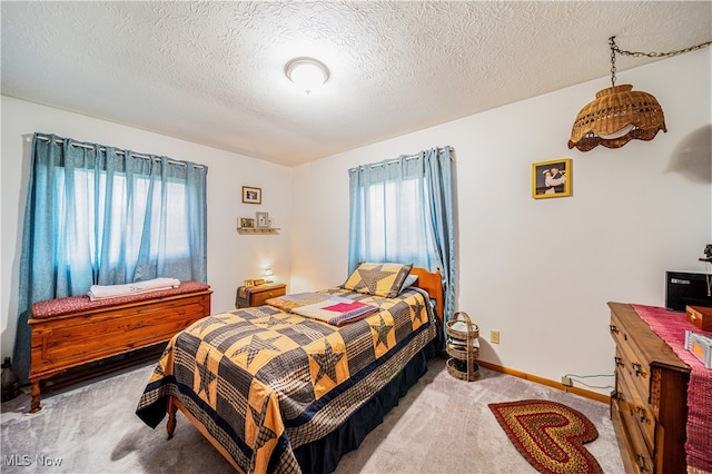 carpeted bedroom with a textured ceiling