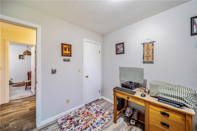 office featuring a textured ceiling and hardwood / wood-style flooring