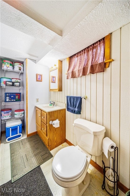 bathroom featuring vanity, toilet, and a textured ceiling