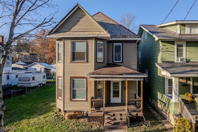 view of front of home with covered porch and a front yard