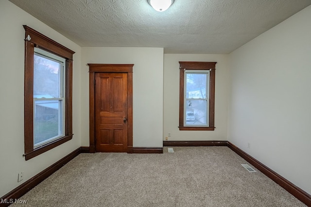 unfurnished bedroom featuring carpet floors and a textured ceiling