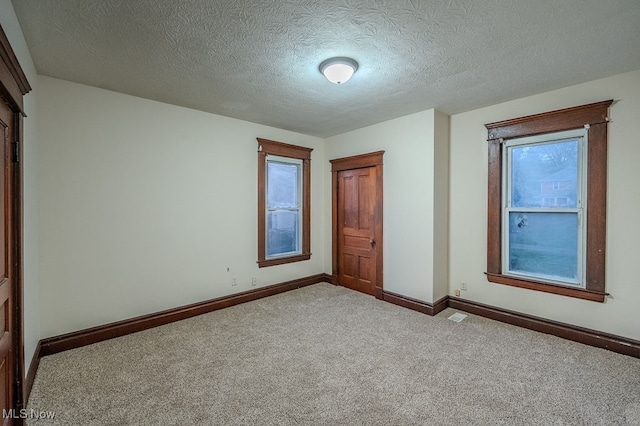 unfurnished bedroom featuring carpet floors and a textured ceiling