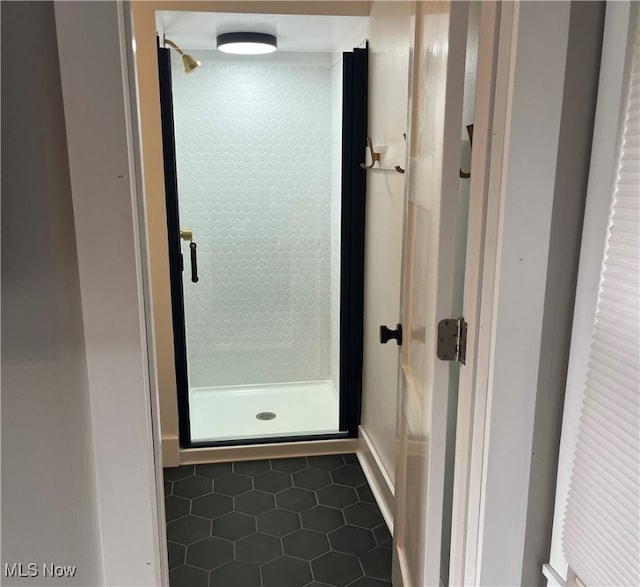 bathroom with tile patterned flooring and walk in shower