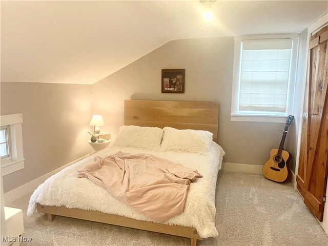 carpeted bedroom with vaulted ceiling