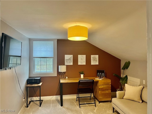 carpeted office with lofted ceiling