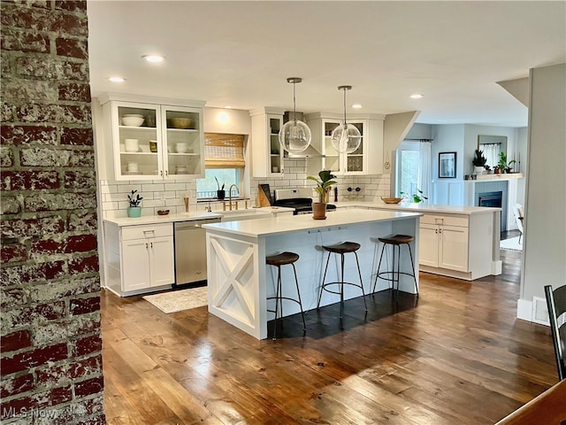 kitchen featuring plenty of natural light, dishwasher, white cabinets, and dark hardwood / wood-style floors