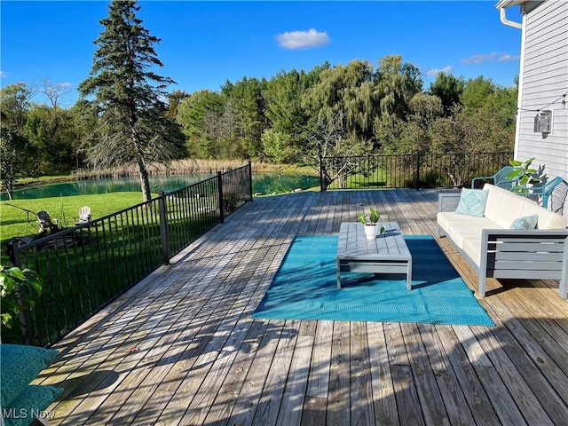 wooden terrace featuring a yard, an outdoor hangout area, and a water view